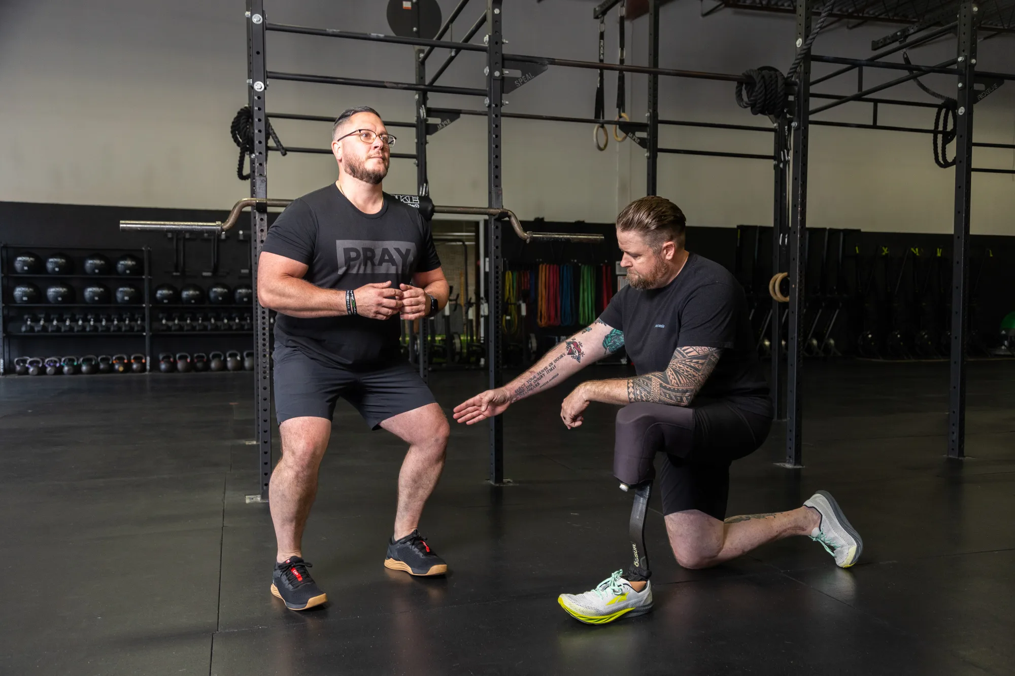 A Nova coach cueing an athlete through a squat
